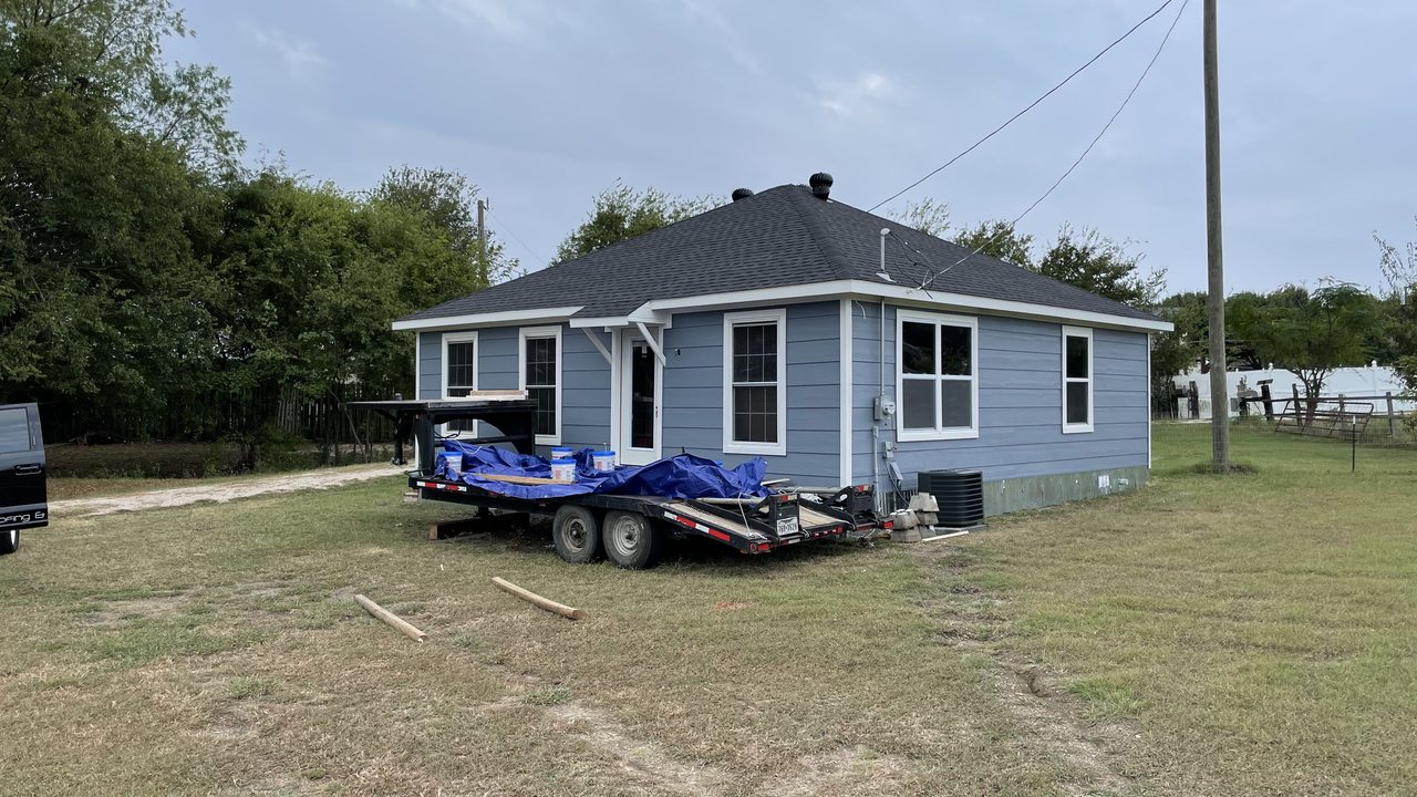 Same home after a fresh light blue-gray exterior repaint by TRC