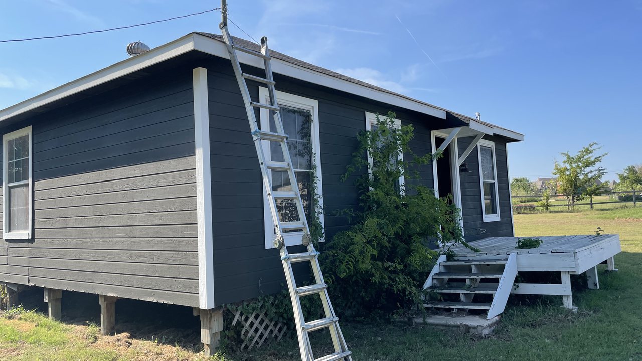 Home with dark, weathered exterior paint before TRC repaint
